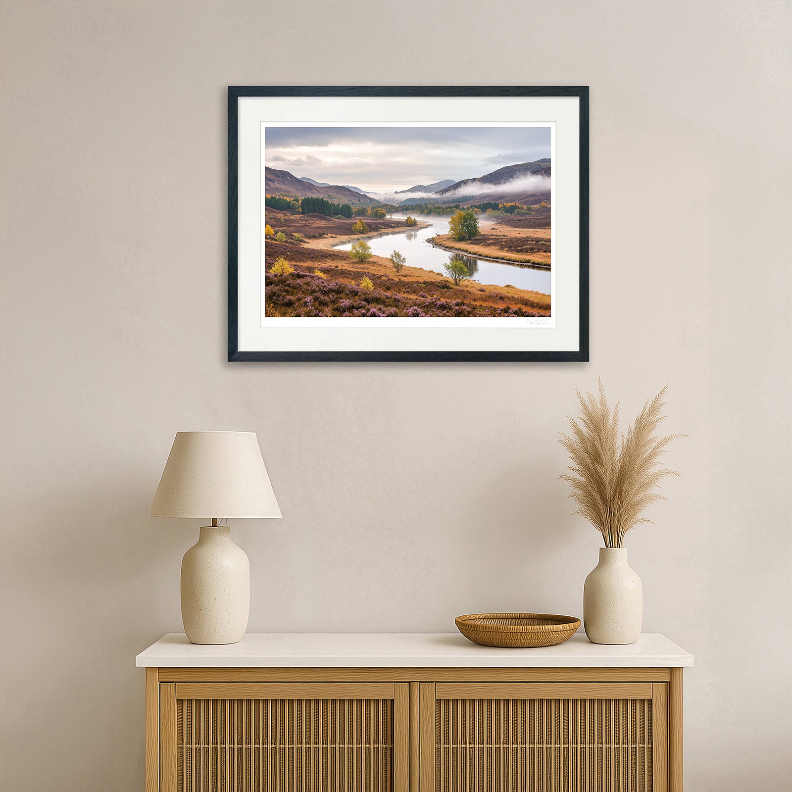 Generative autumn landscape with golden trees and river – framed in natural wooden frame above console table