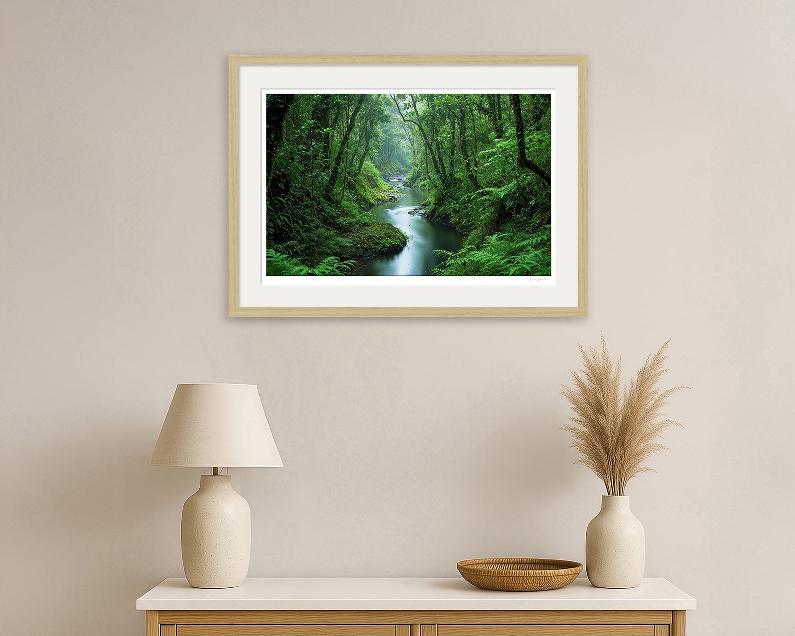 Framed artwork of autumn moorland and river scene with distant deer – black wood frame in home setting