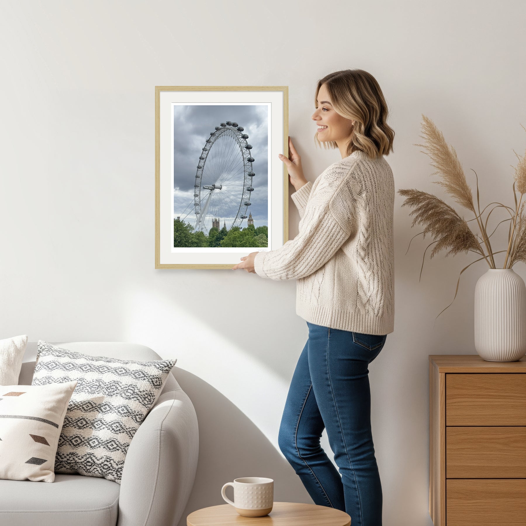 Woman holding London Eye wall art with natural wooden frame, ideal for home interiors