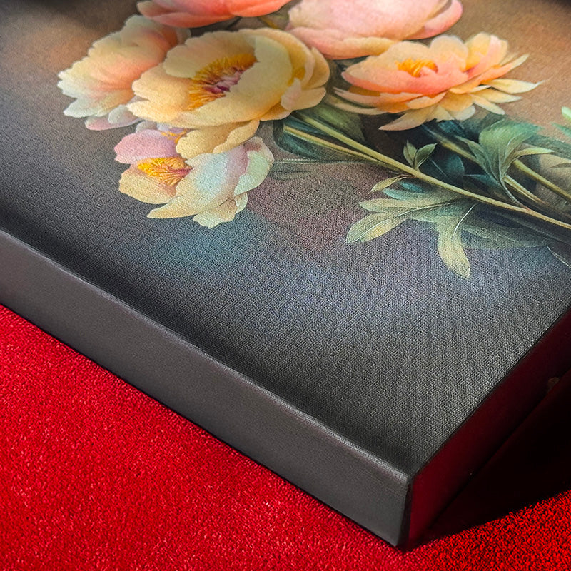 Close-up of a premium, gallery-wrapped canvas print featuring soft yellow and pink floral artwork, showcasing the quality of the print and the dark edge of the frame.