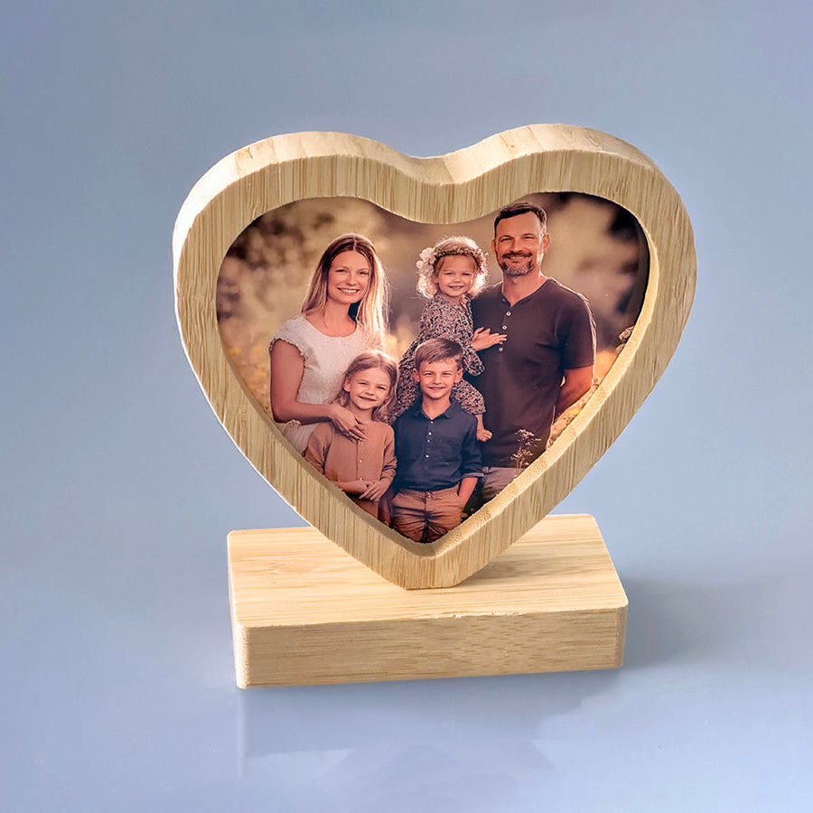 Heart-shaped bamboo desk frame showcasing a family photo, perfect for personalized gifts and home decor.