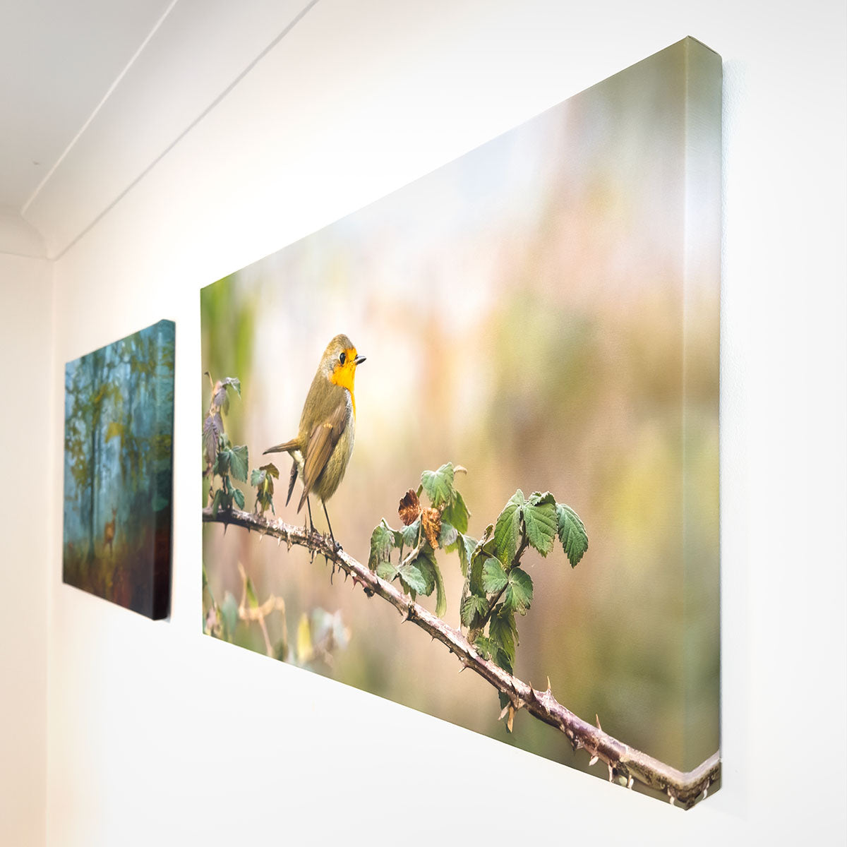 Large nature-themed art print featuring two colorful birds on a branch, displayed on a white wall in a modern interior, illustrating how the artwork enhances a living space