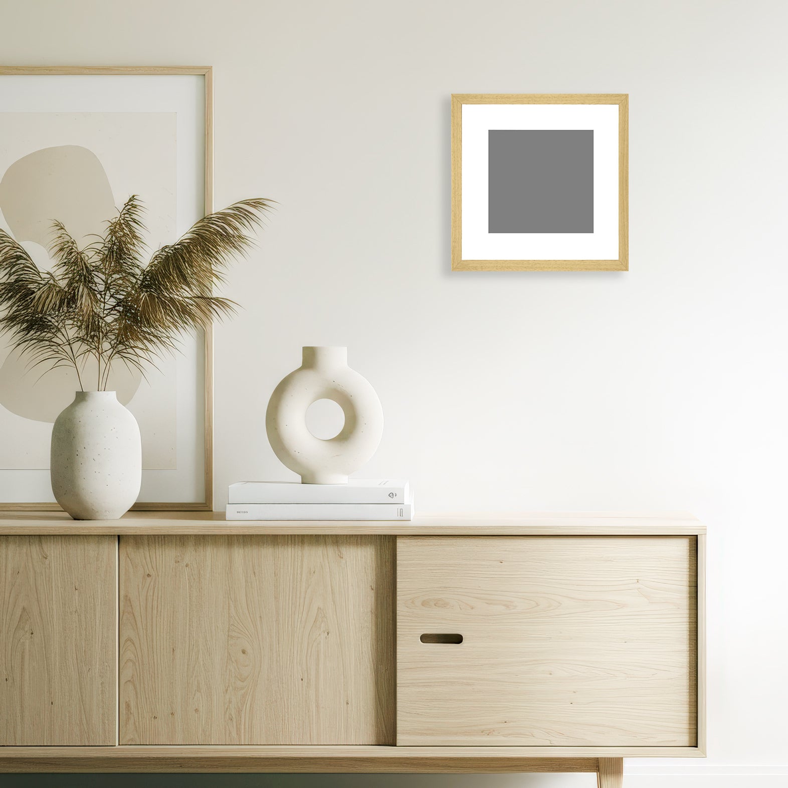Natural wood grain magnetic frame with a 30x30 cm giclée print, mounted above a minimalist sideboard in a modern neutral-toned living room.