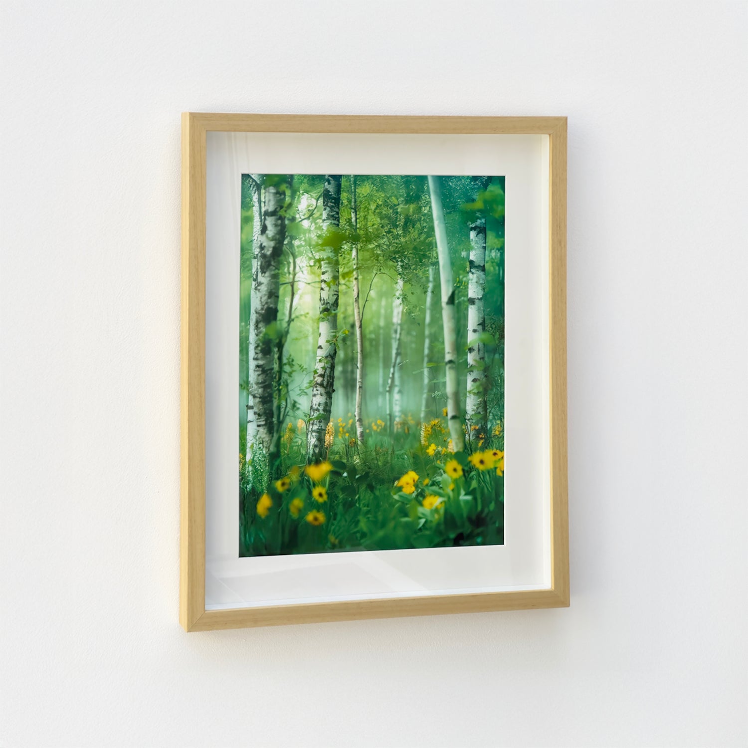 Natural wood shadow box frame with green forest artwork, shown hanging on a white wall.