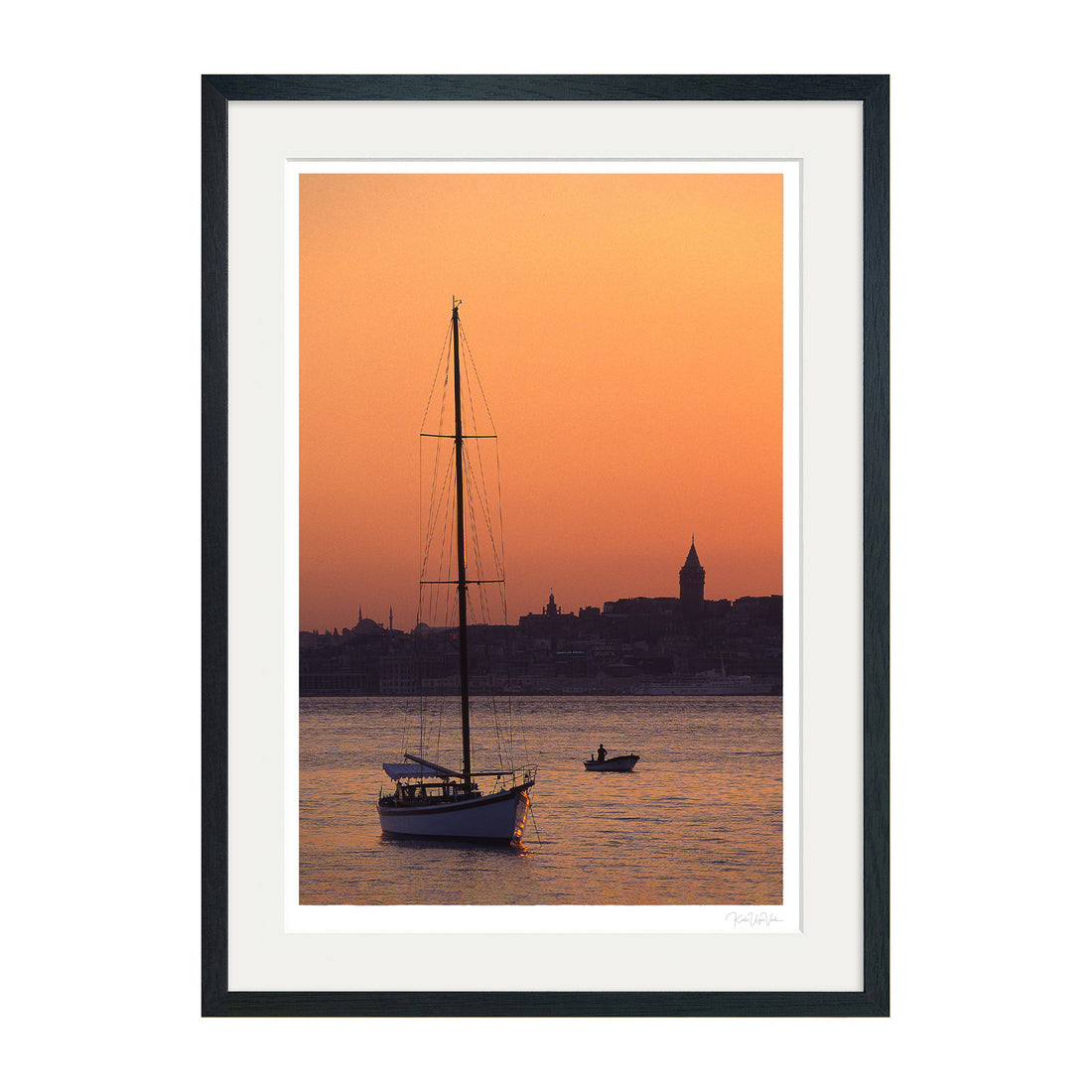 Framed Istanbul wall art showing a sailboat at sunset with Galata Tower in the background – black frame