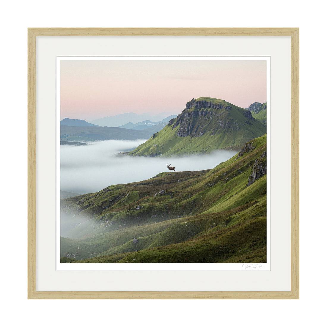 Limited edition fine art print of a stag in misty green mountains, framed with natural oak wood and museum-grade mount.


