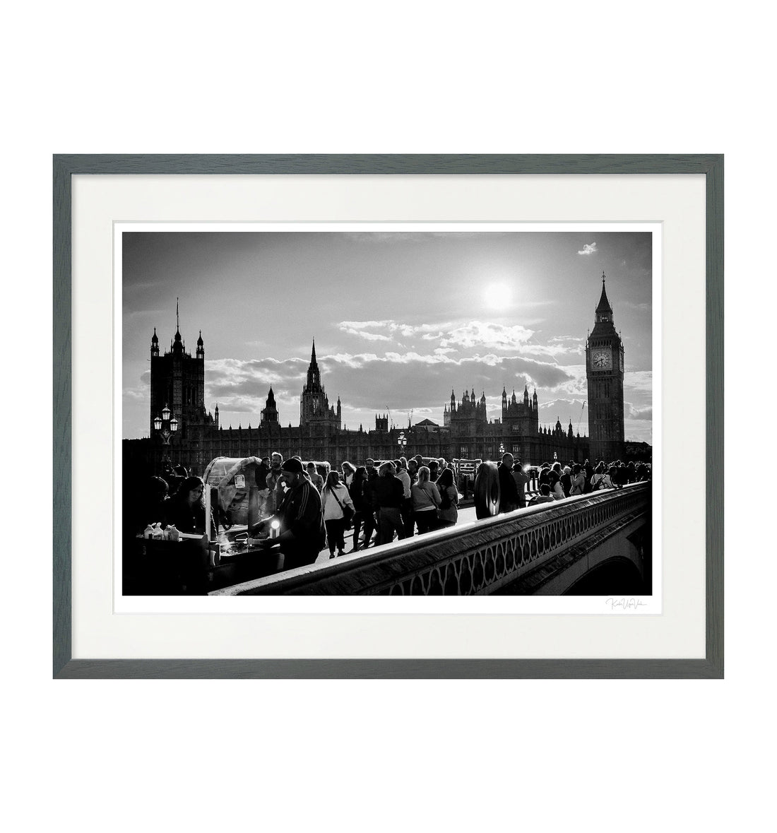 Framed black and white wall art print of Westminster Bridge and Big Ben with street life, grey wooden frame, fine art photography by Kadir Ugur Varli.