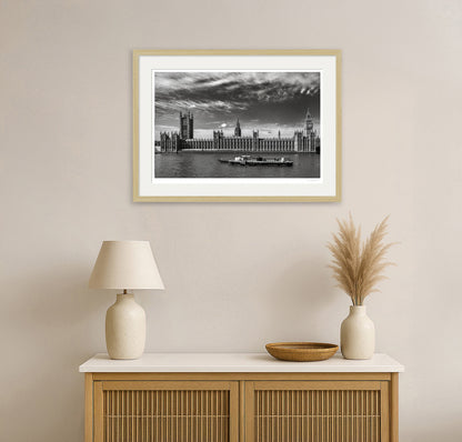 Black and white framed London cityscape print above natural wood console in minimalist home interior