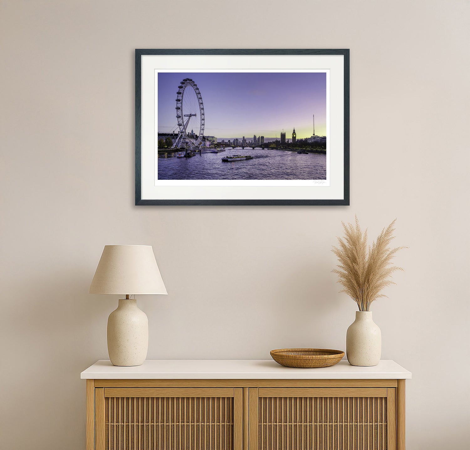 Colourful London cityscape wall art featuring the London Eye and Big Ben, displayed in a modern living room with neutral decor and wooden cabinet.

