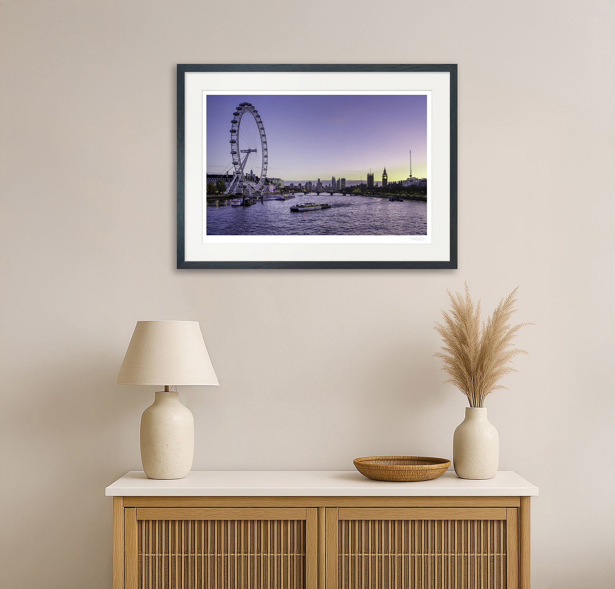 Colourful London cityscape wall art featuring the London Eye and Big Ben, displayed in a modern living room with neutral decor and wooden cabinet.

