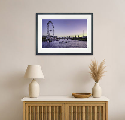 Colourful London cityscape wall art featuring the London Eye and Big Ben, displayed in a modern living room with neutral decor and wooden cabinet.

