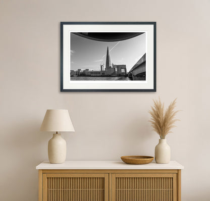 Black framed The Shard London cityscape print displayed above a neutral-toned sideboard in a contemporary living room.