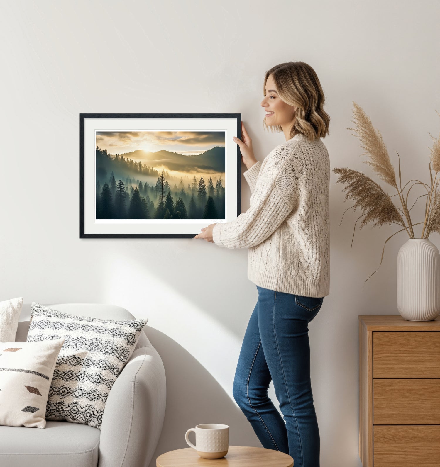 Woman holding golden hour misty forest framed wall art in black frame – interior inspiration photo