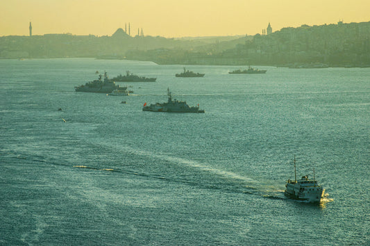 A lone vessel crossing a hazy Bosphorus with Istanbul's misty skyline of minarets and rooftops dissolving in the distance, fine art photography print
