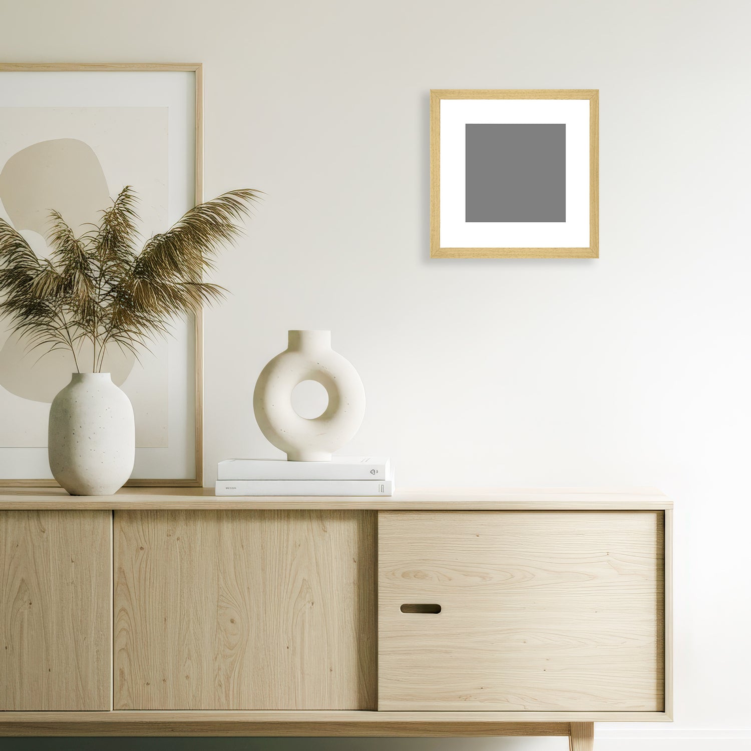 Natural wood grain magnetic frame with a 30x30 cm giclée print, mounted above a minimalist sideboard in a modern neutral-toned living room.