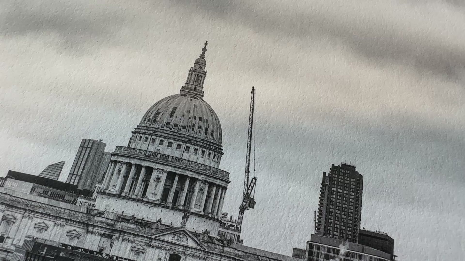 Load video: Close-up of Hahnemühle Photo Rag 308gsm fine art print featuring architectural black and white image – shows paper texture and print detail